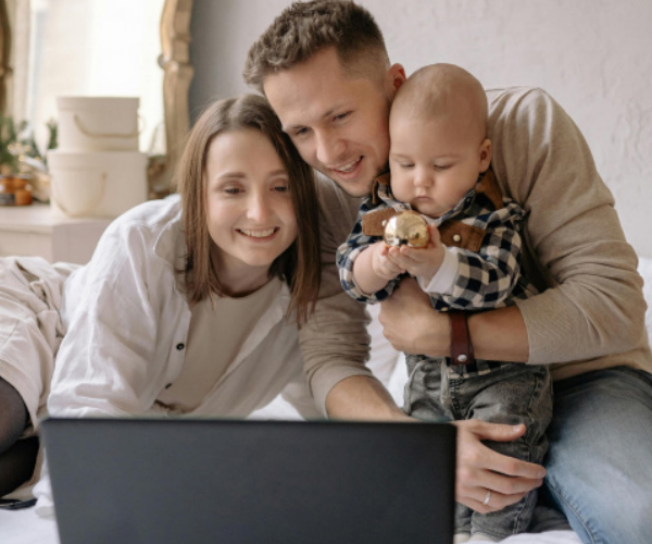 Happy family sitting together and using internet